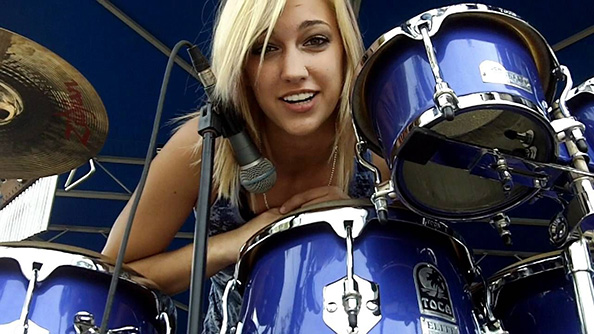 A female drummer in a studio
